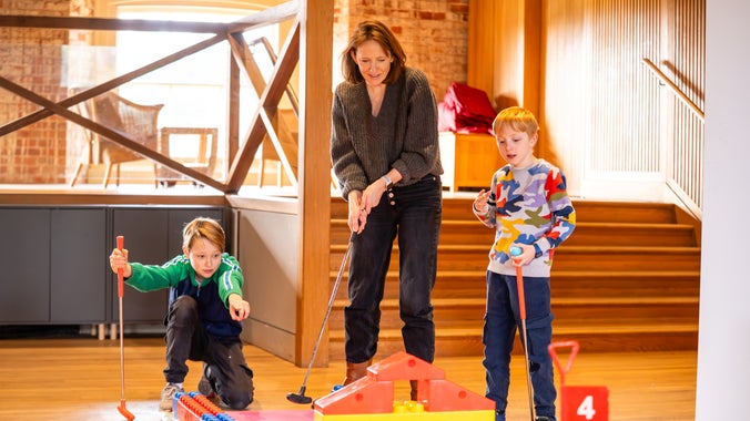 A family playing indoor golf at Ickworth